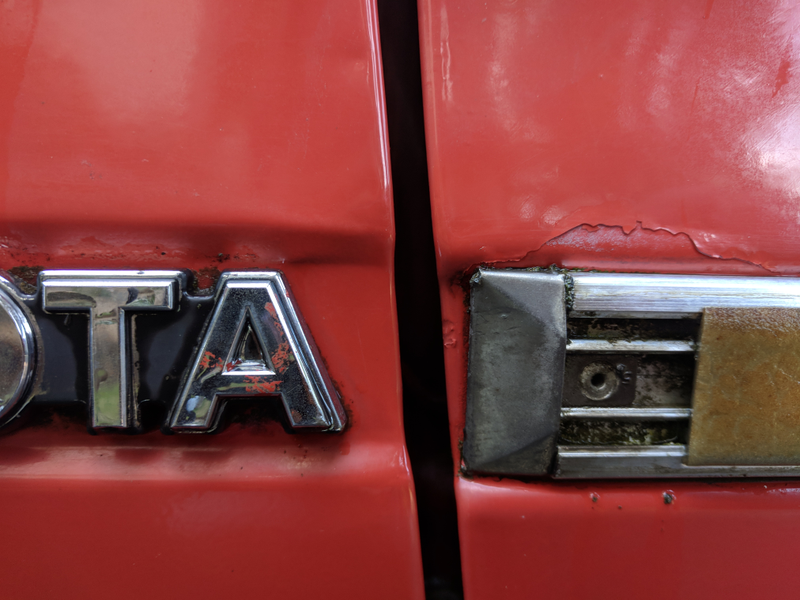 Overspray on badge, plus newer respray chipping off easily.